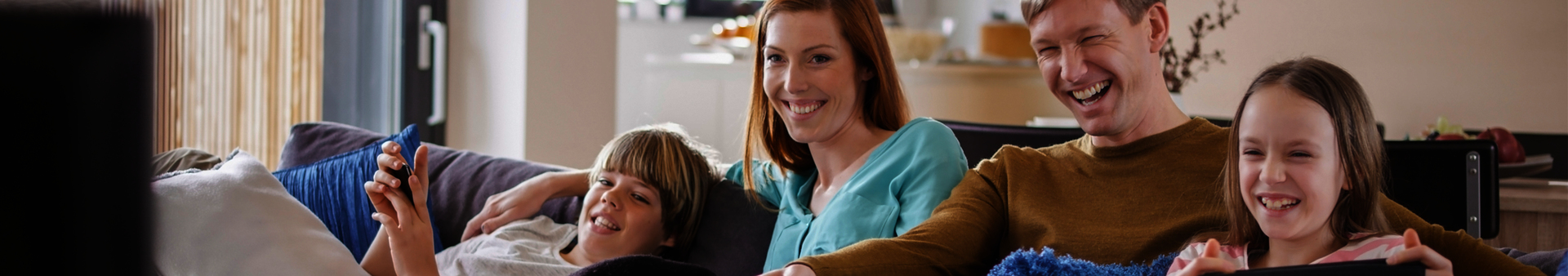 Family laughing at tv