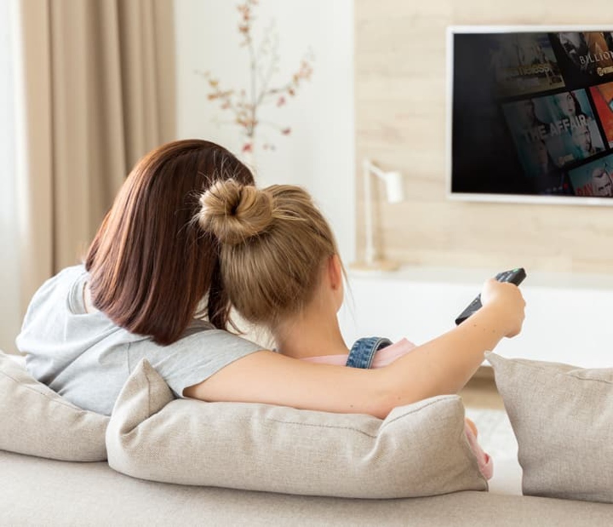 People on couch watching TV